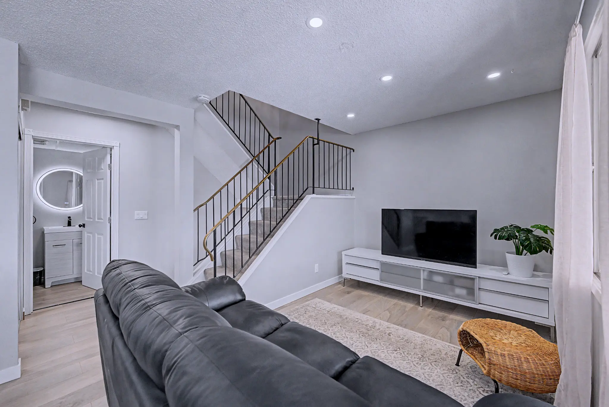 Renovated Braeside townhouse interior with stair rail and living area